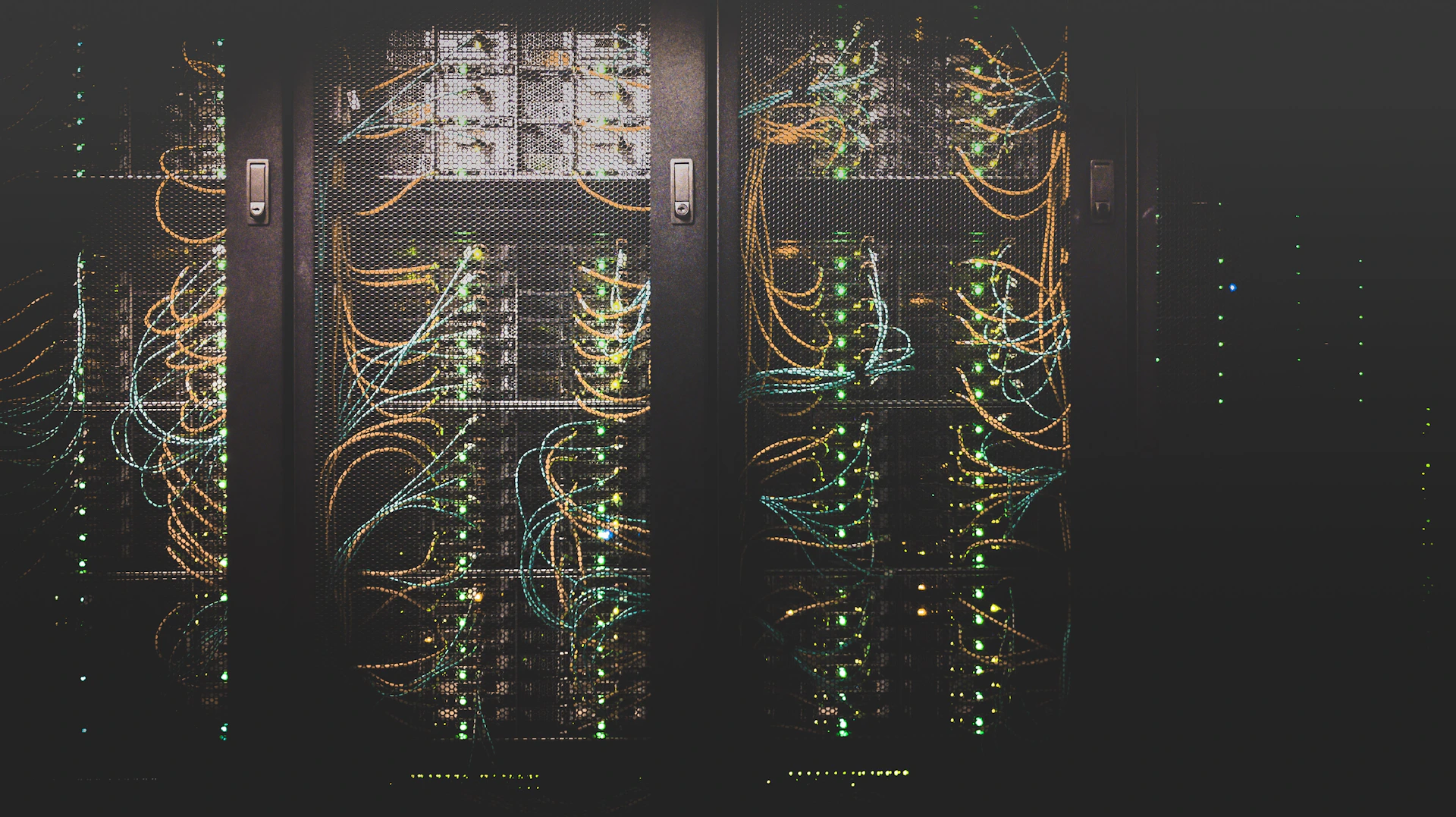 Server room corridor lit in cool blue light, representing monitored infrastructure