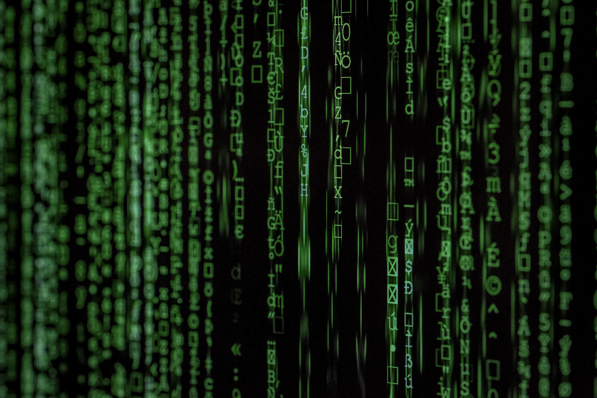 Streams of code on a dark screen, representing continuous monitoring of network traffic